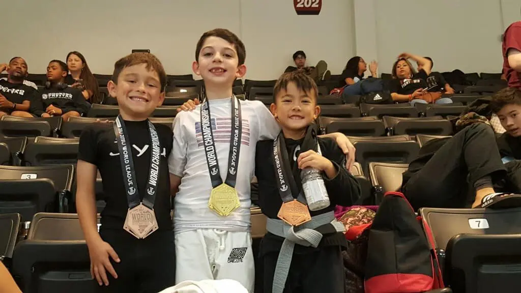 Three young Jiyu students showing their Jiu Jitsu World League medals